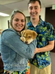 Man and woman with adopted brown pup