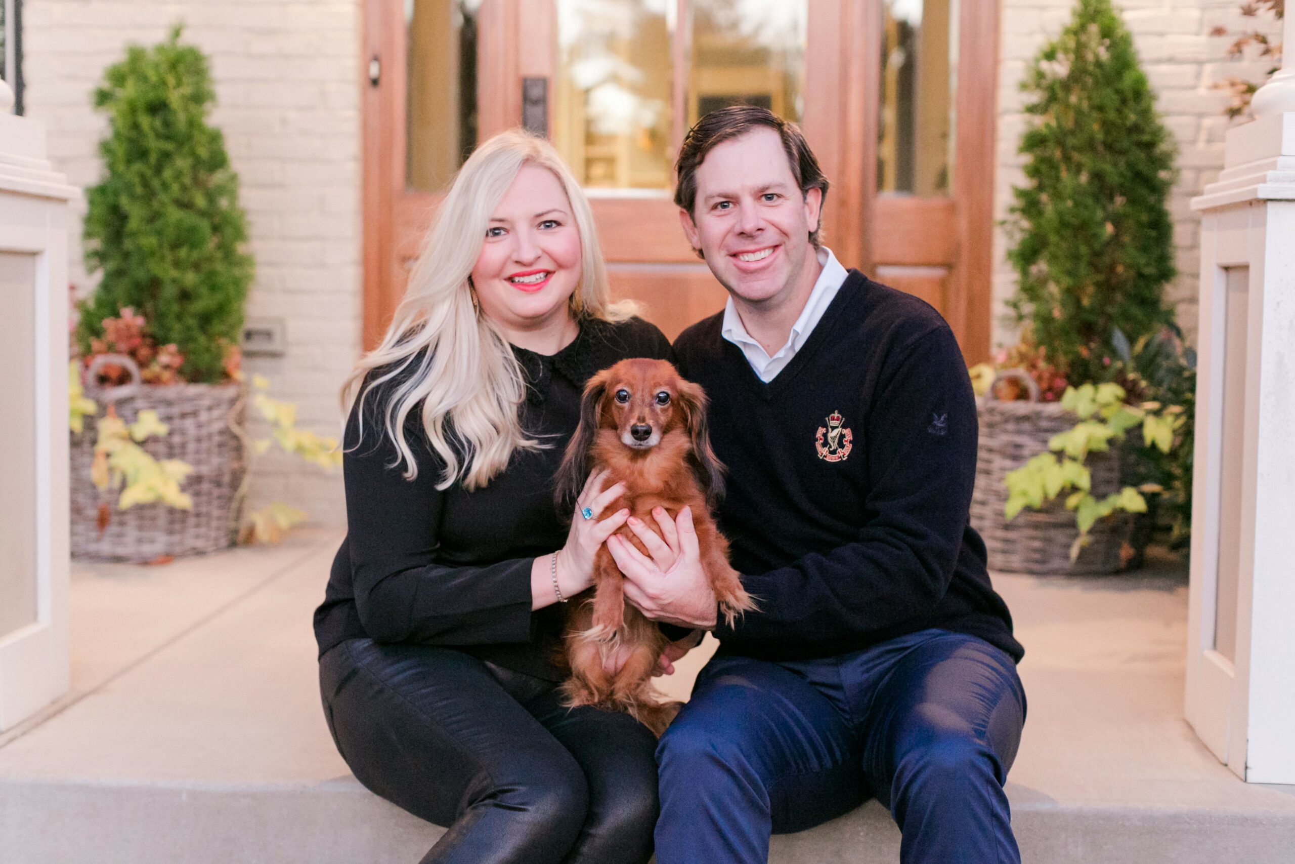 Man and woman holding dog Hattie glamour after adoption